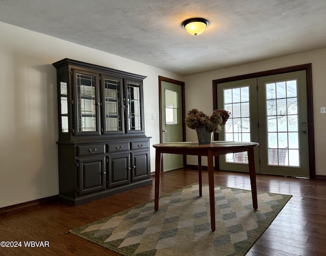 dining space with dark hardwood / wood-style floors