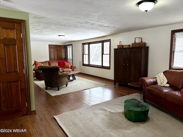 living room featuring a textured ceiling and dark hardwood / wood-style floors