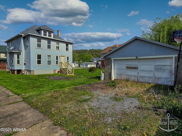 402 N Lincoln Ave, Jersey Shore, PA 17740 - view of property exterior featuring a chimney, a lawn, and a detached garage