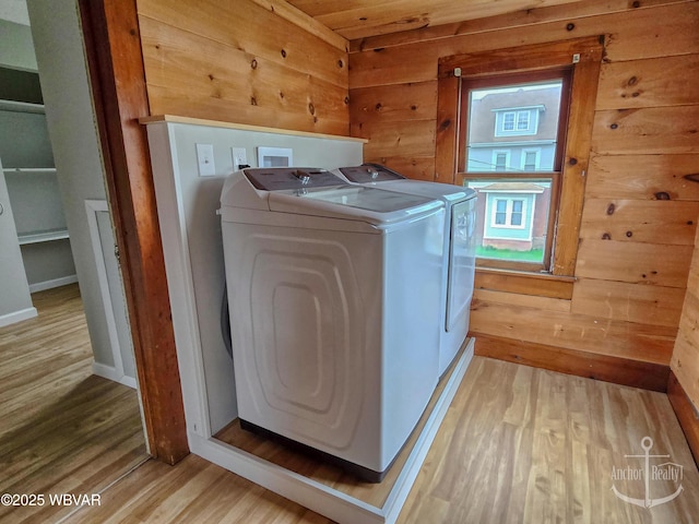 402 N Lincoln Ave, Jersey Shore, PA 17740 - laundry area with separate washer and dryer, light wood-type flooring, baseboards, and wooden walls