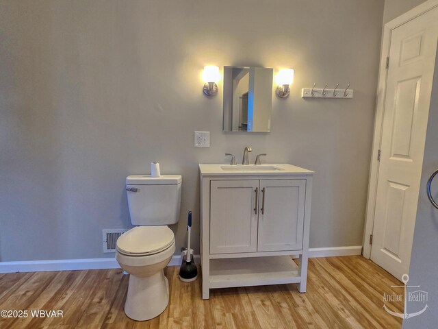 402 N Lincoln Ave, Jersey Shore, PA 17740 - bathroom featuring vanity, wood finished floors, toilet, and baseboards