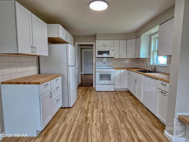 402 N Lincoln Ave, Jersey Shore, PA 17740 - kitchen featuring white appliances, butcher block countertops, a sink, decorative backsplash, and light wood finished floors