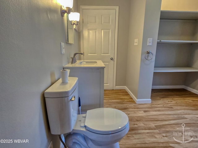 402 N Lincoln Ave, Jersey Shore, PA 17740 - bathroom with a sink, toilet, wood finished floors, and baseboards