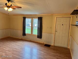 unfurnished room with hardwood / wood-style floors and ceiling fan