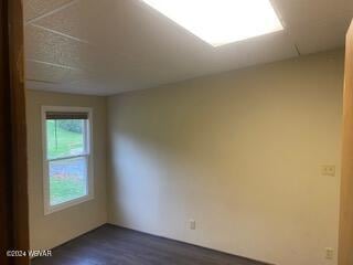 empty room with dark hardwood / wood-style floors