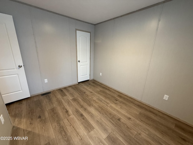 empty room with light hardwood / wood-style floors