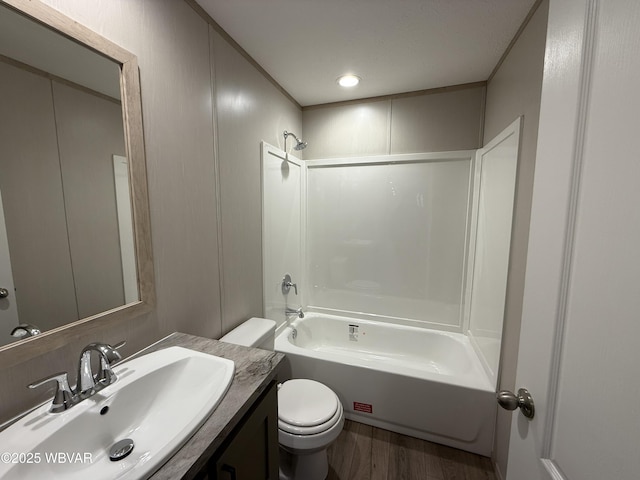 full bathroom featuring vanity, bathing tub / shower combination, hardwood / wood-style flooring, and toilet