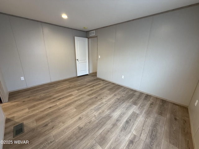 unfurnished room with light hardwood / wood-style floors