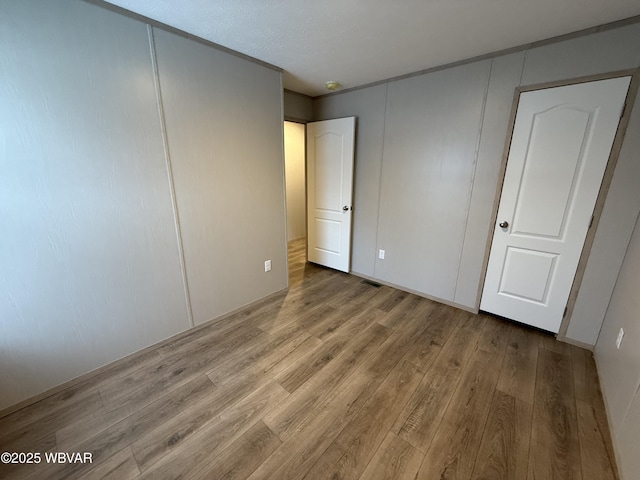 unfurnished bedroom with light hardwood / wood-style floors