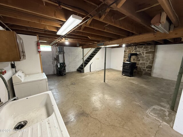 309 W Keller St, Lock Haven, PA 17745 - below grade area featuring washer and clothes dryer, stairway, a wood stove, and a heating unit