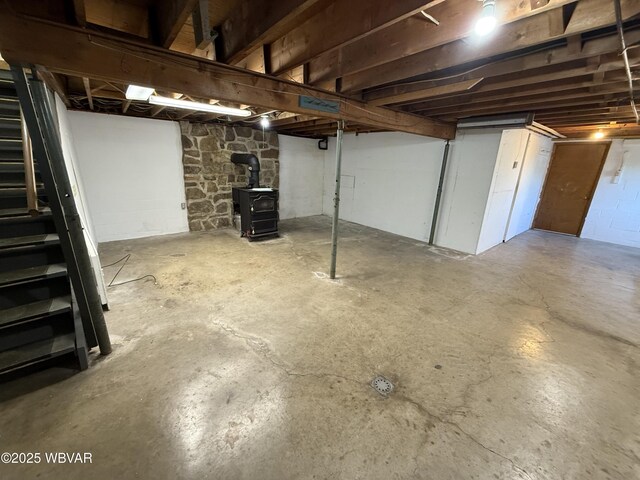 309 W Keller St, Lock Haven, PA 17745 - unfinished basement featuring a wood stove and stairs