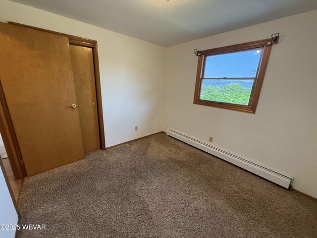 309 W Keller St, Lock Haven, PA 17745 - spare room featuring a baseboard radiator and dark colored carpet