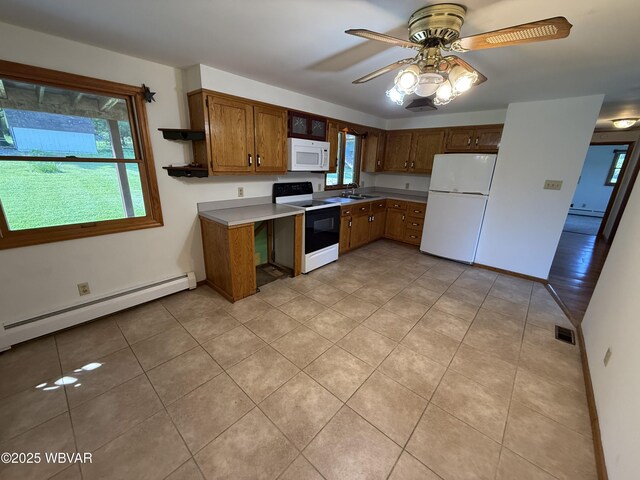 309 W Keller St, Lock Haven, PA 17745 - kitchen featuring white appliances, baseboard heating, and plenty of natural light