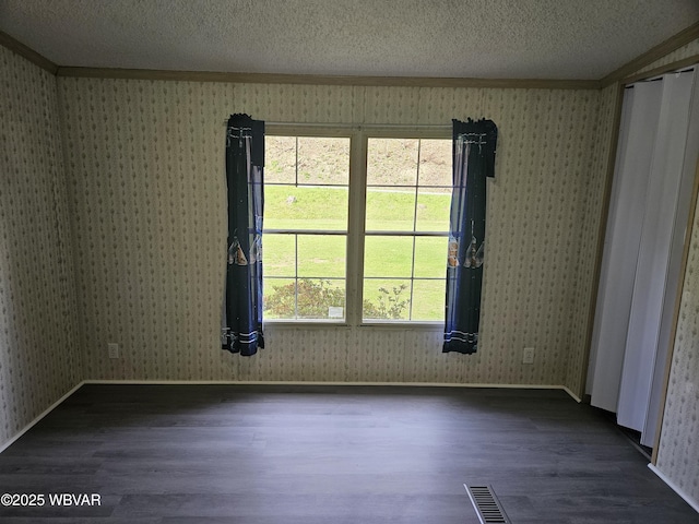 1592 Cement Hollow Rd, Jersey Shore, PA 17740 - spare room with dark wood finished floors, visible vents, crown molding, and wallpapered walls