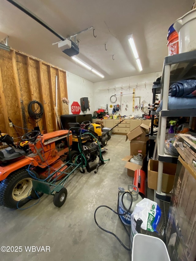 garage with a workshop area and a garage door opener