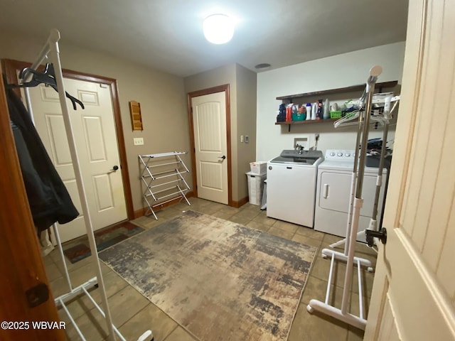 clothes washing area with light tile patterned floors and washer and clothes dryer