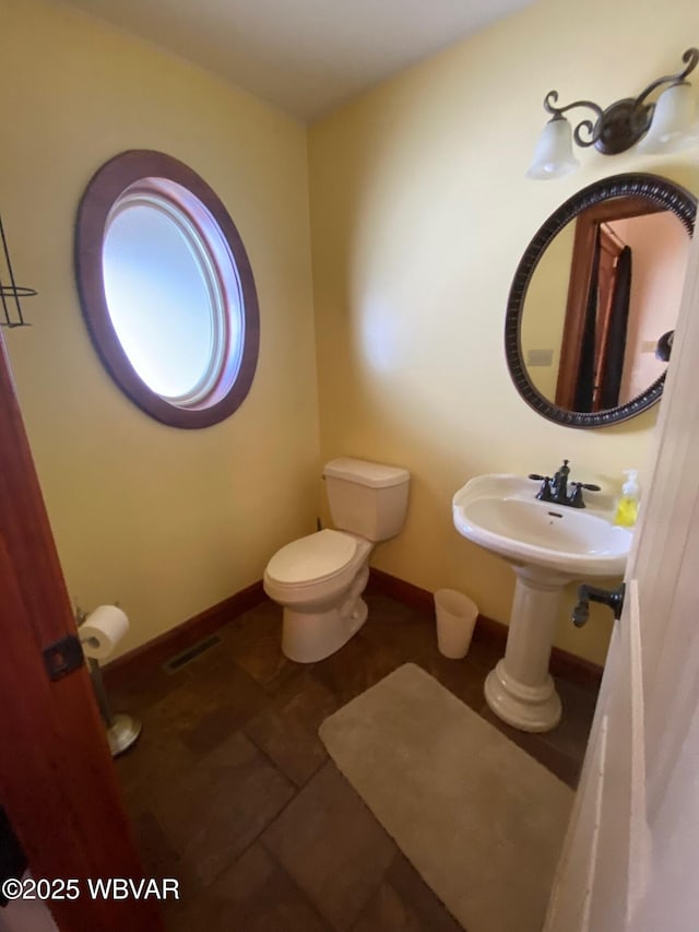 bathroom featuring toilet and tile patterned floors