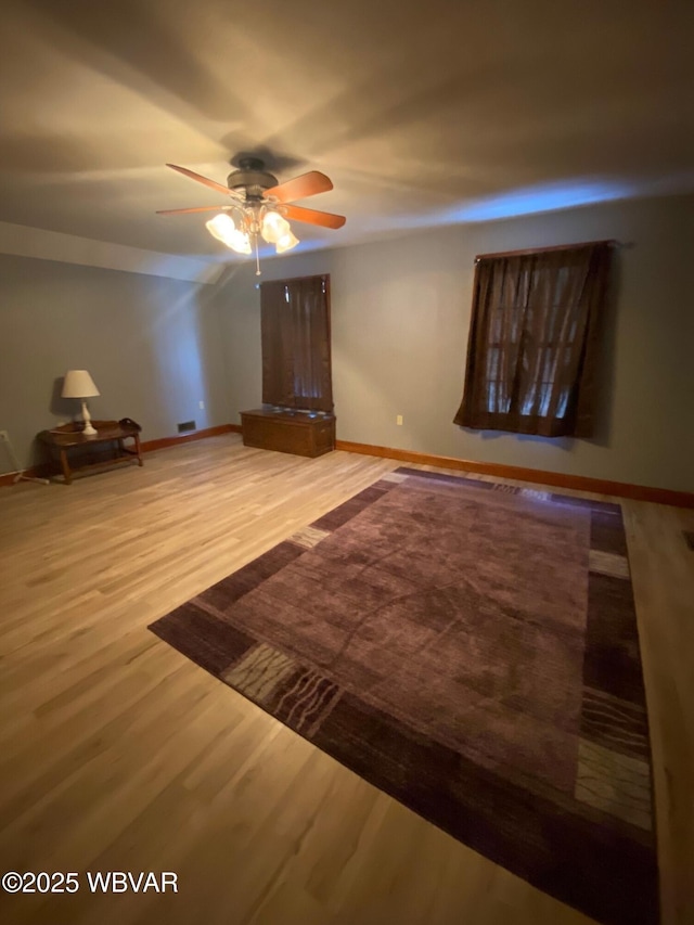 unfurnished bedroom with ceiling fan and hardwood / wood-style flooring