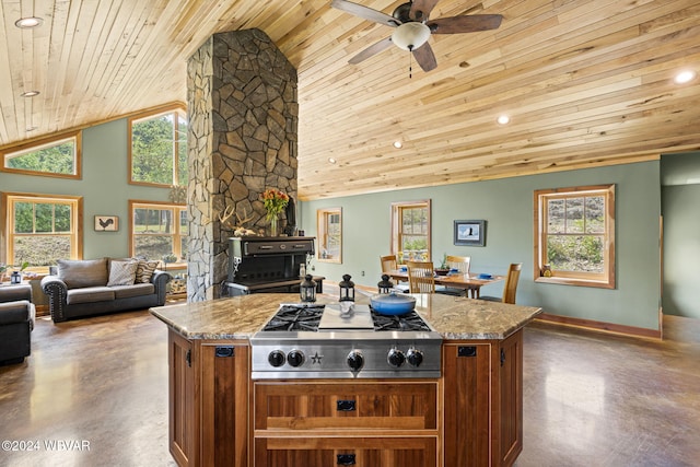 kitchen with a healthy amount of sunlight, stainless steel gas stovetop, finished concrete floors, and brown cabinetry