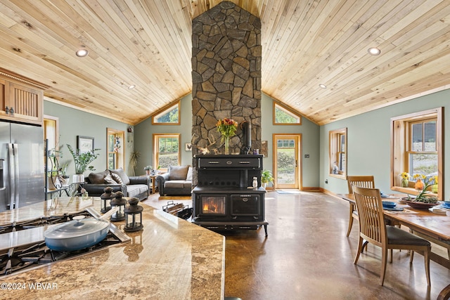 kitchen with a wood stove, wood ceiling, high vaulted ceiling, and stainless steel fridge with ice dispenser