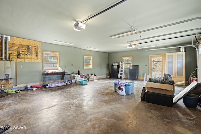 garage with a garage door opener and water heater