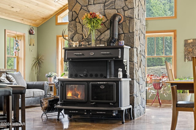 living room featuring a wood stove, wood ceiling, and high vaulted ceiling