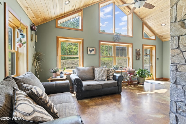 living area featuring a fireplace, finished concrete floors, wood ceiling, ceiling fan, and high vaulted ceiling