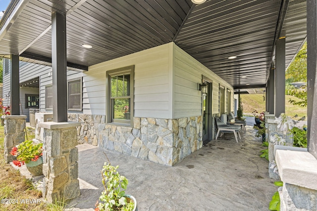 view of property exterior featuring covered porch and stone siding