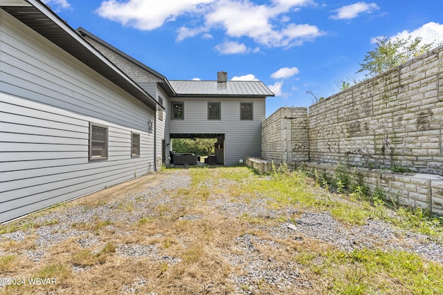 view of yard with dirt driveway and fence