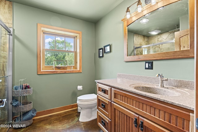 full bath featuring a stall shower, toilet, vanity, and baseboards