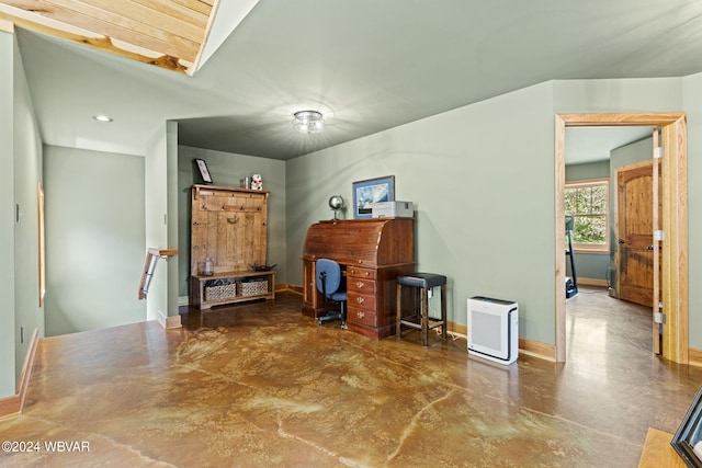 interior space with finished concrete floors, a skylight, and baseboards