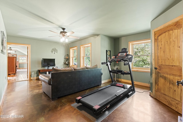 workout area with ceiling fan and baseboards