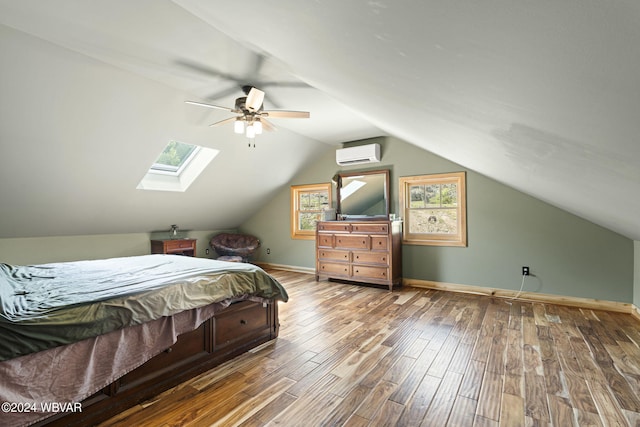 bedroom with vaulted ceiling, an AC wall unit, wood finished floors, and baseboards