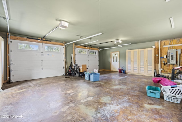 garage featuring electric panel and a garage door opener