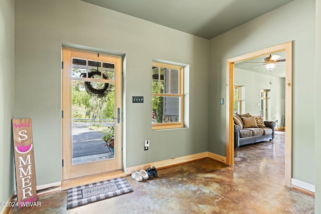 entryway with concrete flooring and baseboards