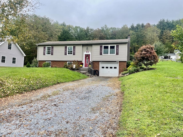 raised ranch with a garage and a front lawn