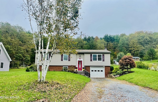 bi-level home featuring a garage and a front lawn