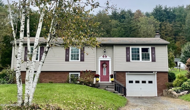 bi-level home with a front yard and a garage