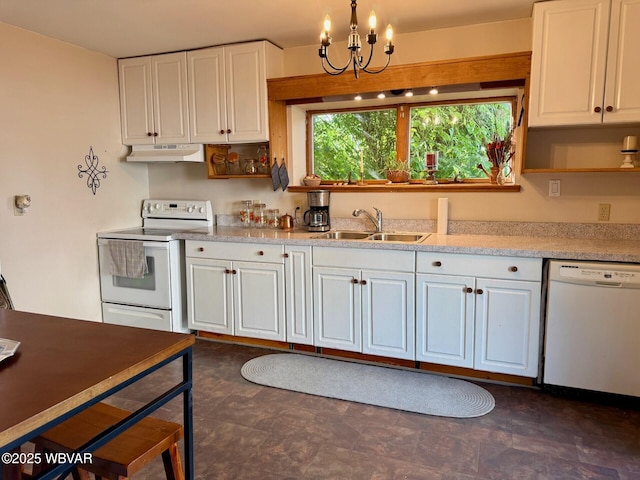 61 W Houston Ave, Montgomery, PA 17752 - kitchen with white appliances, under cabinet range hood, light countertops, white cabinets, and a chandelier