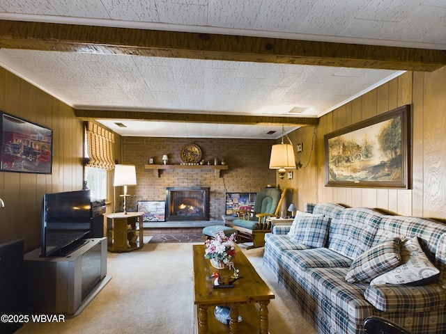 living room with carpet flooring, beamed ceiling, wooden walls, and a brick fireplace