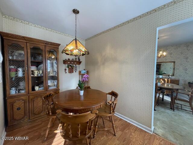 dining room featuring hardwood / wood-style flooring and an inviting chandelier