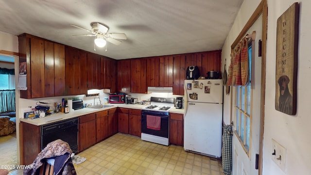 kitchen featuring white appliances, ceiling fan, wooden walls, and sink