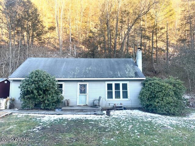 rear view of house with a yard