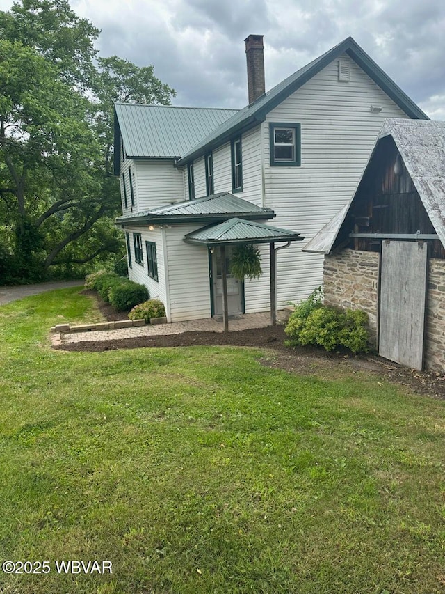 rear view of property featuring a yard