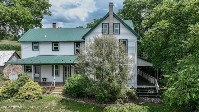 106 Cresent Hill Rd, Cogan Station, PA 17728 - back of property featuring a porch, a chimney, and a metal roof