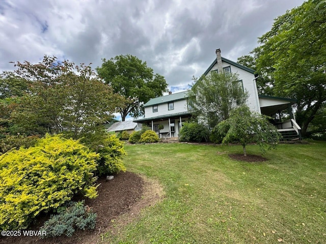 view of yard featuring covered porch