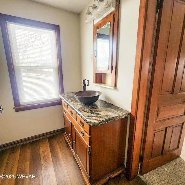 bathroom with vanity, hardwood / wood-style floors, and a healthy amount of sunlight