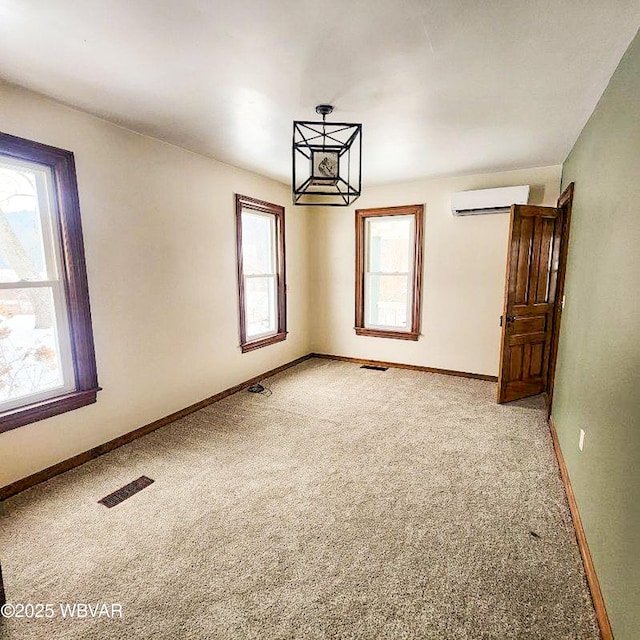 carpeted empty room featuring a wall unit AC