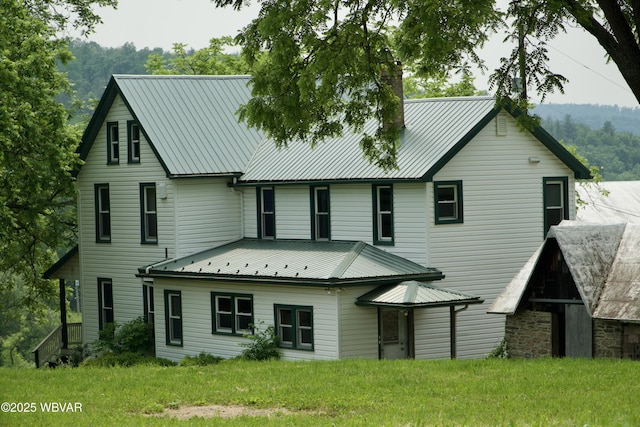 106 Cresent Hill Rd, Cogan Station, PA 17728 - back of property featuring a metal roof, a chimney, and a lawn