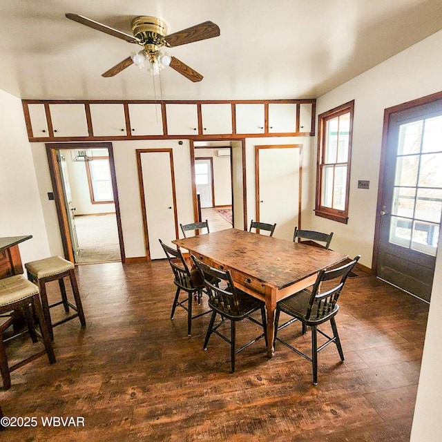 dining area featuring ceiling fan, a healthy amount of sunlight, and dark hardwood / wood-style floors